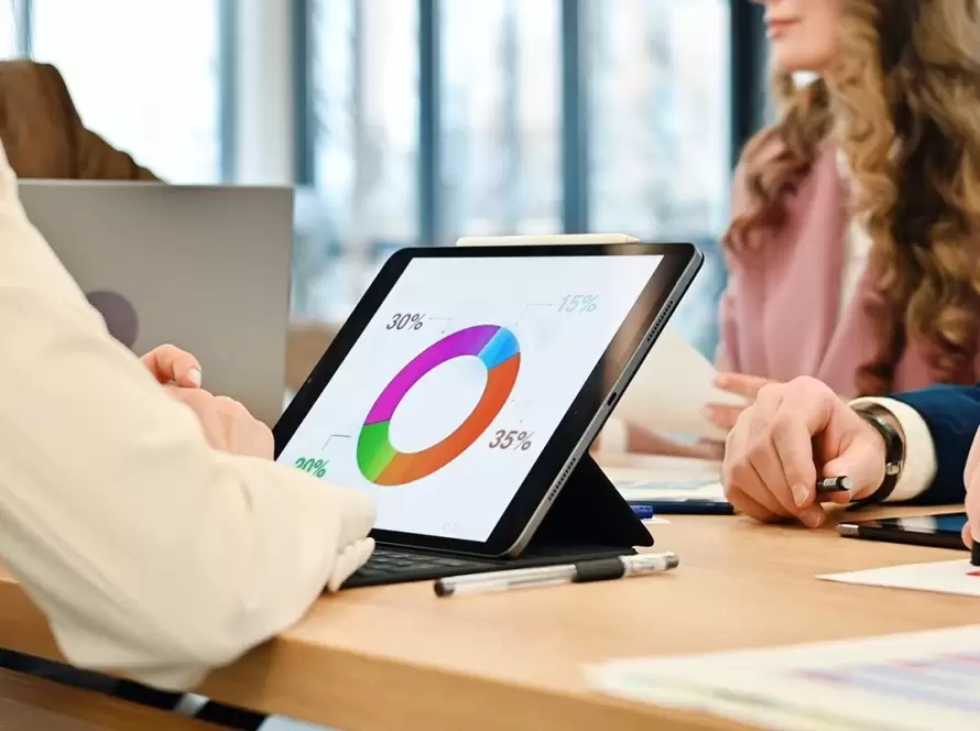 Marketing team reviewing law firm agency results on a tablet showing how long campaigns take to perform